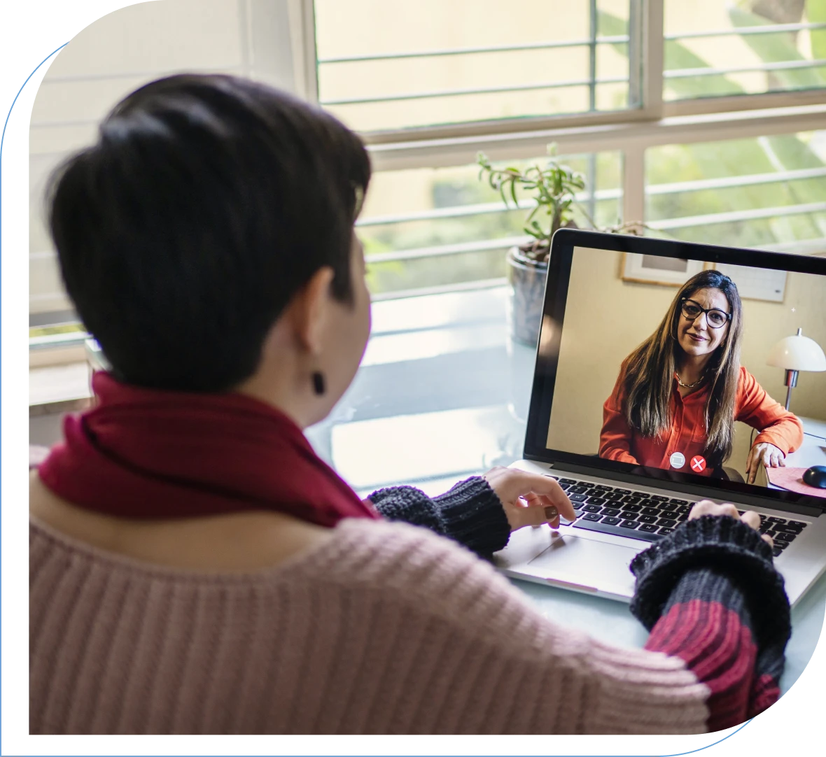 Woman on laptop video call with friend.